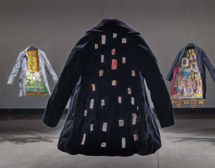 An installation view of Meera Sethi's multimedia artwork Outerwhere featuring a series of coats embellished with a variety of fabrics.