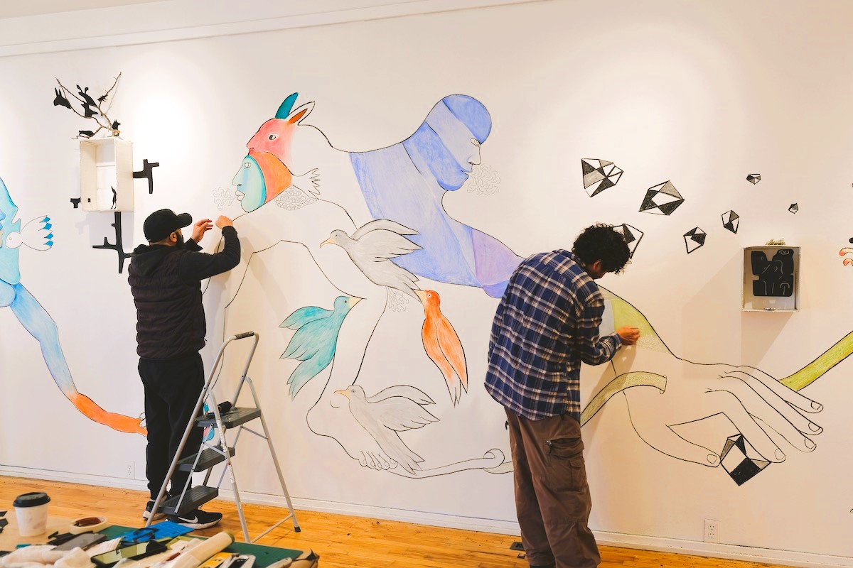 Promotional banner of event "Art Bus: Tour with Z'otz* Collective" at the Varley Art Gallery of Markham, featuring the Z'otz* Collective working on a mural artwork in the background