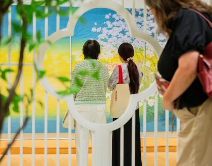 Three visitors viewing a Chinese gongbi landscape painting in the Varley Art Gallery of Markham.